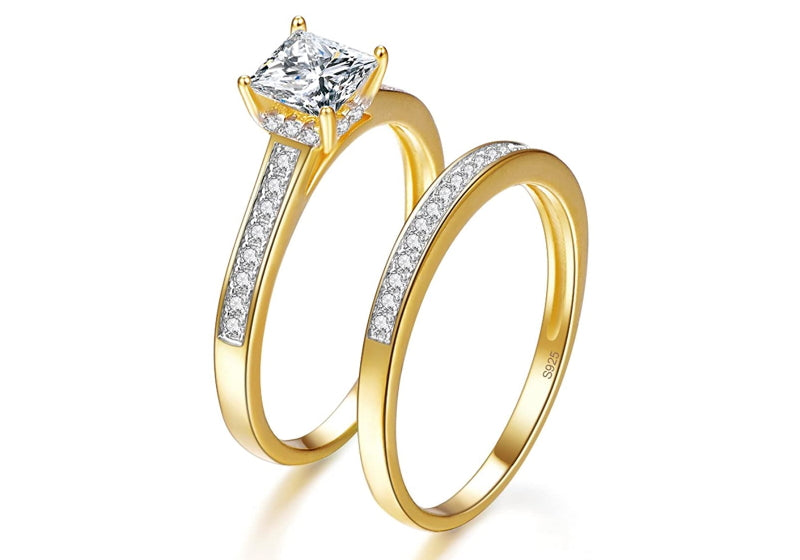 2 gold engagement rings with a 925 marking inside the ring