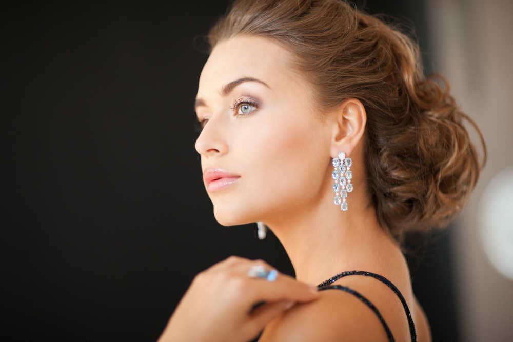 Image by SydaProductions via Shutterstock -  woman wearing diamond earrings